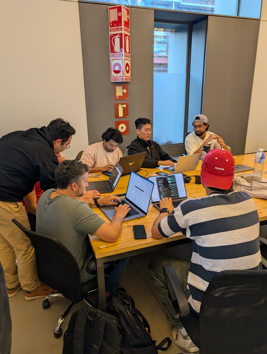 Builders at their laptops around a long table