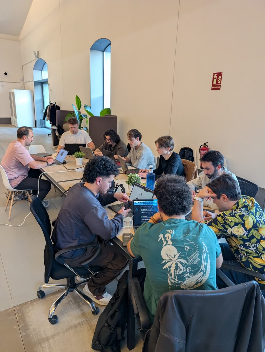 A team working on laptops in a bright room