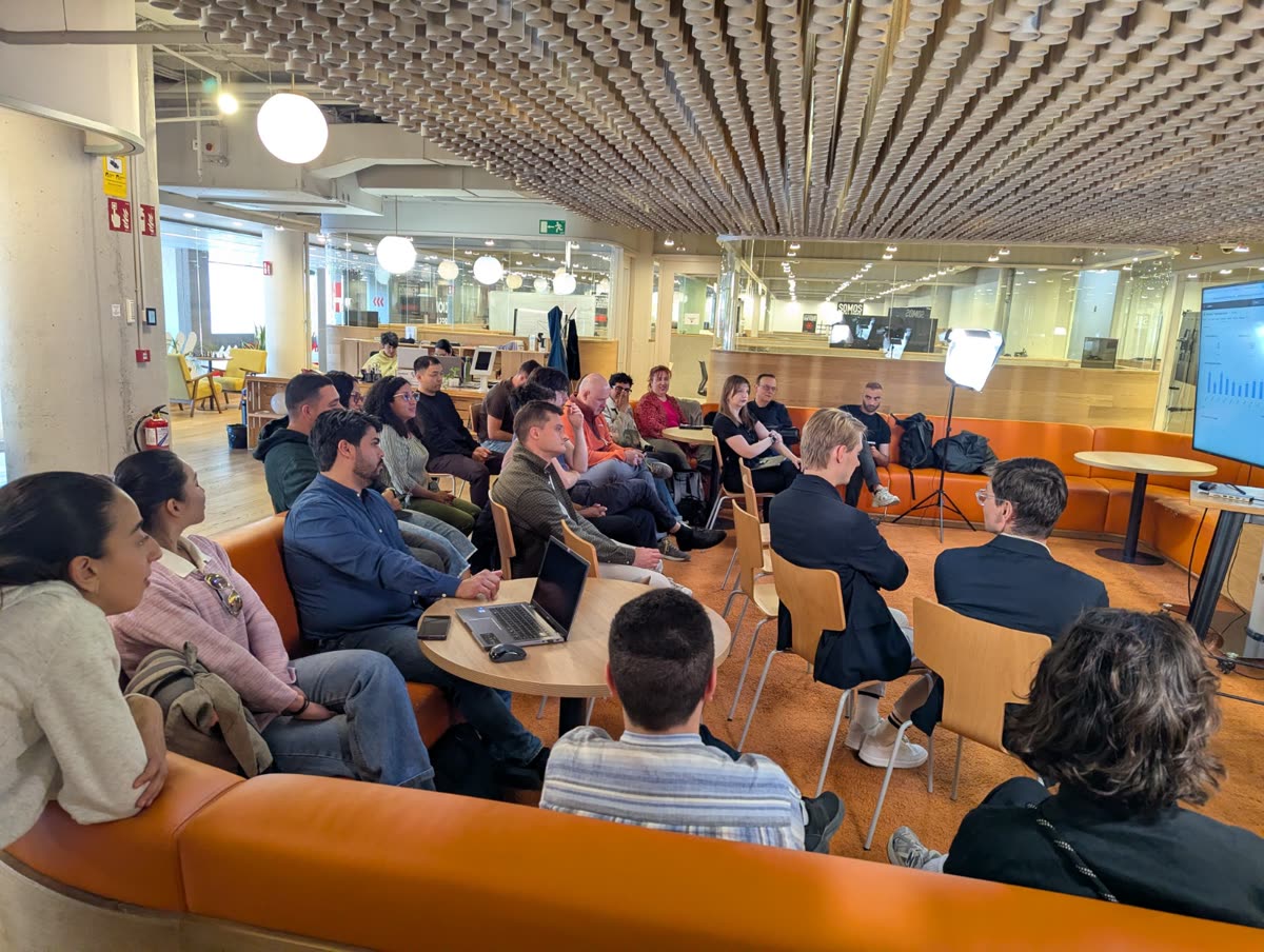 A talk in a large lounge, the audience in a circle