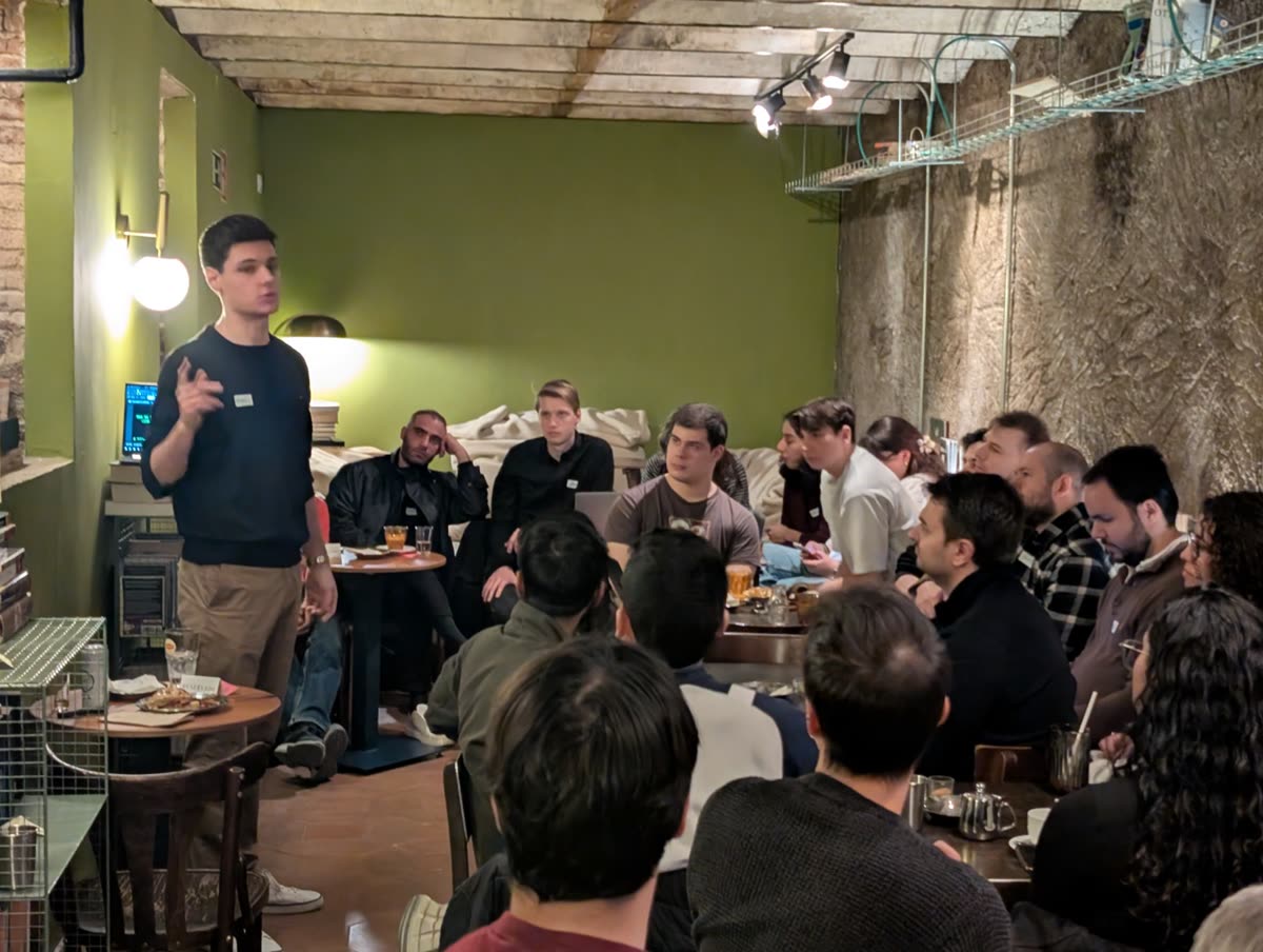 A speaker standing in front of a seated audience