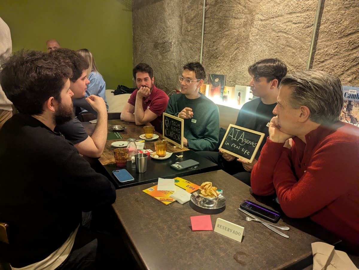 A table discussion with a sign that reads AI agents in real life
